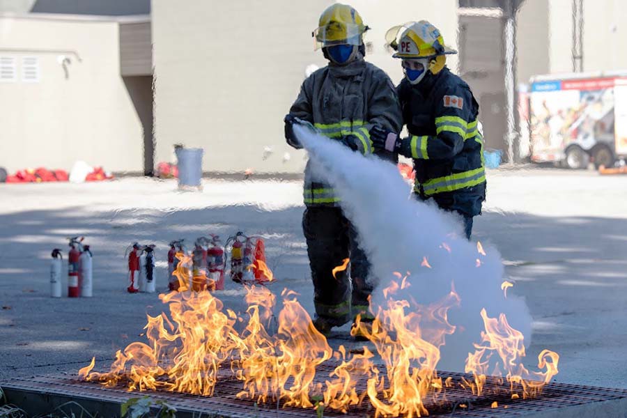 A student gets instruction on using a extinguisher during camp ignite. 