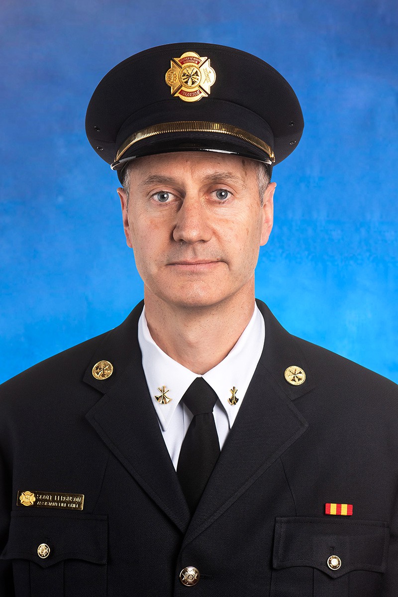 A headshot of Scott Ferguson, assistant fire chief – operations, in a formal blue uniform.
