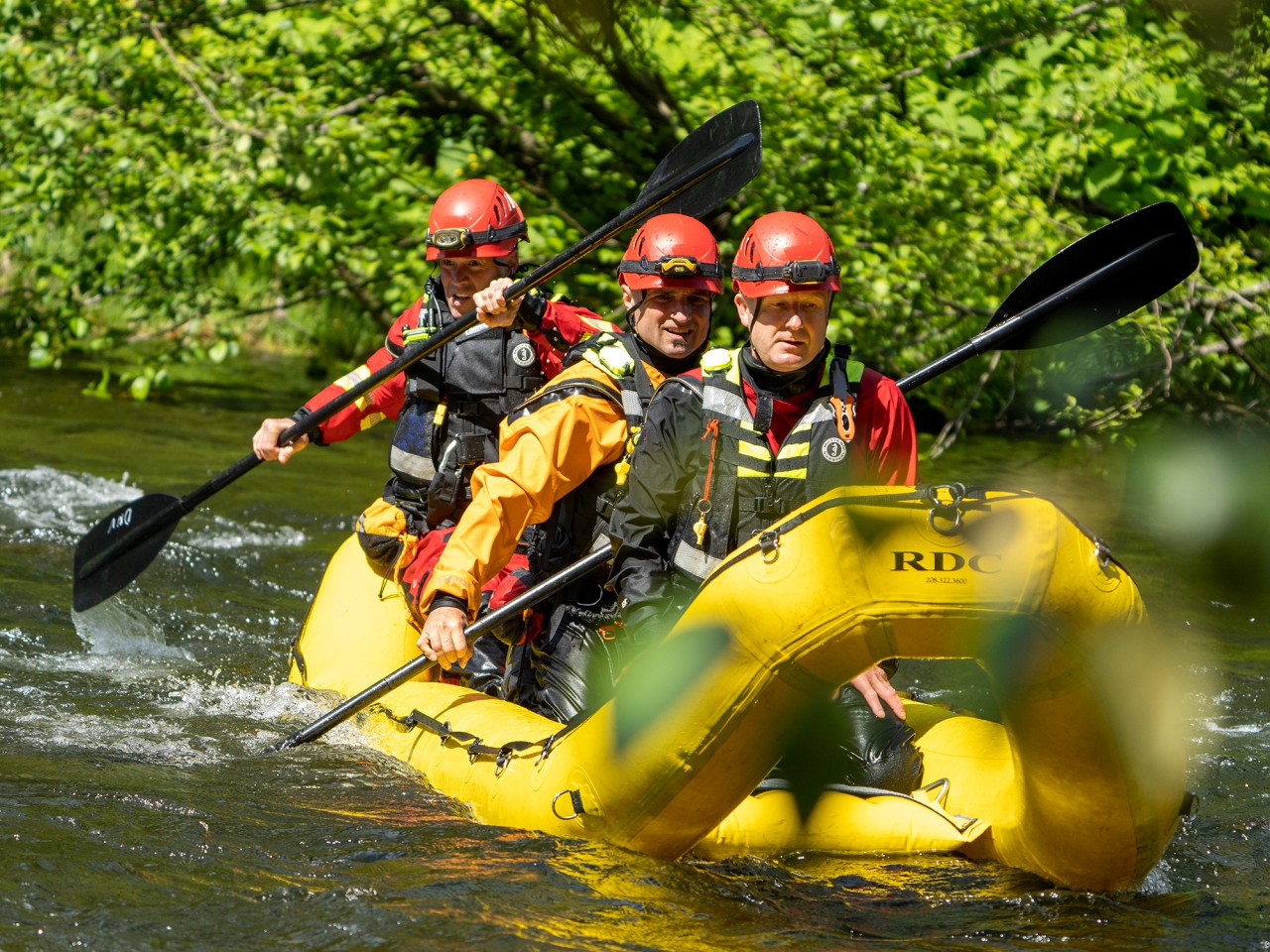A group of firefighters practise swiftwater rescue.