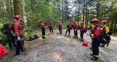 Firefighters with axes preparing to fight forest fire