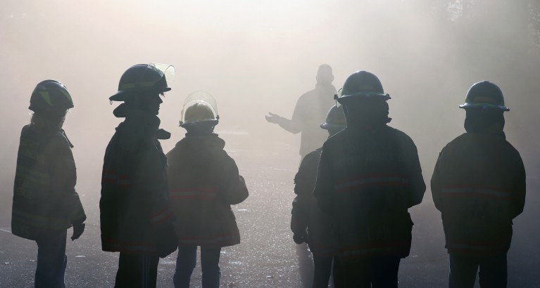 Group of fire firefighters surrounded by smoke
