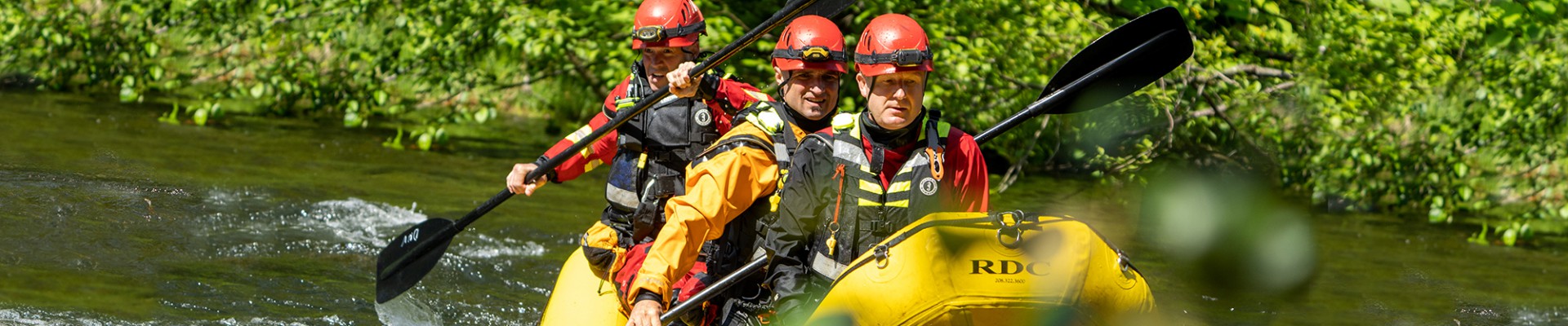 A group of firefighters practise swiftwater rescue.