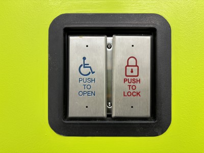 A close-up of an automatic door opener with a Push to Open button and Push to Lock button.