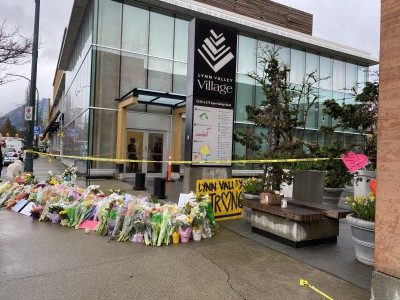 Flowers and written tributes at the Lynn Valley Village memorial. 