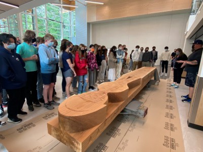 Students learning about the Welcome Figure and carving process.