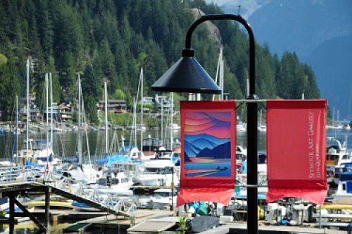 Street light with decorate banner in front of Deep Cove marina